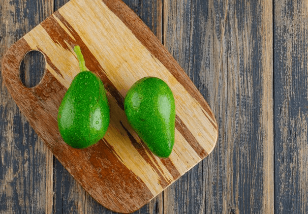 Fuerte avocados on wooden board