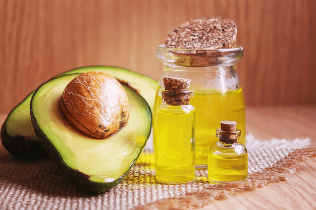 Avocado oil bottles with fresh avocado